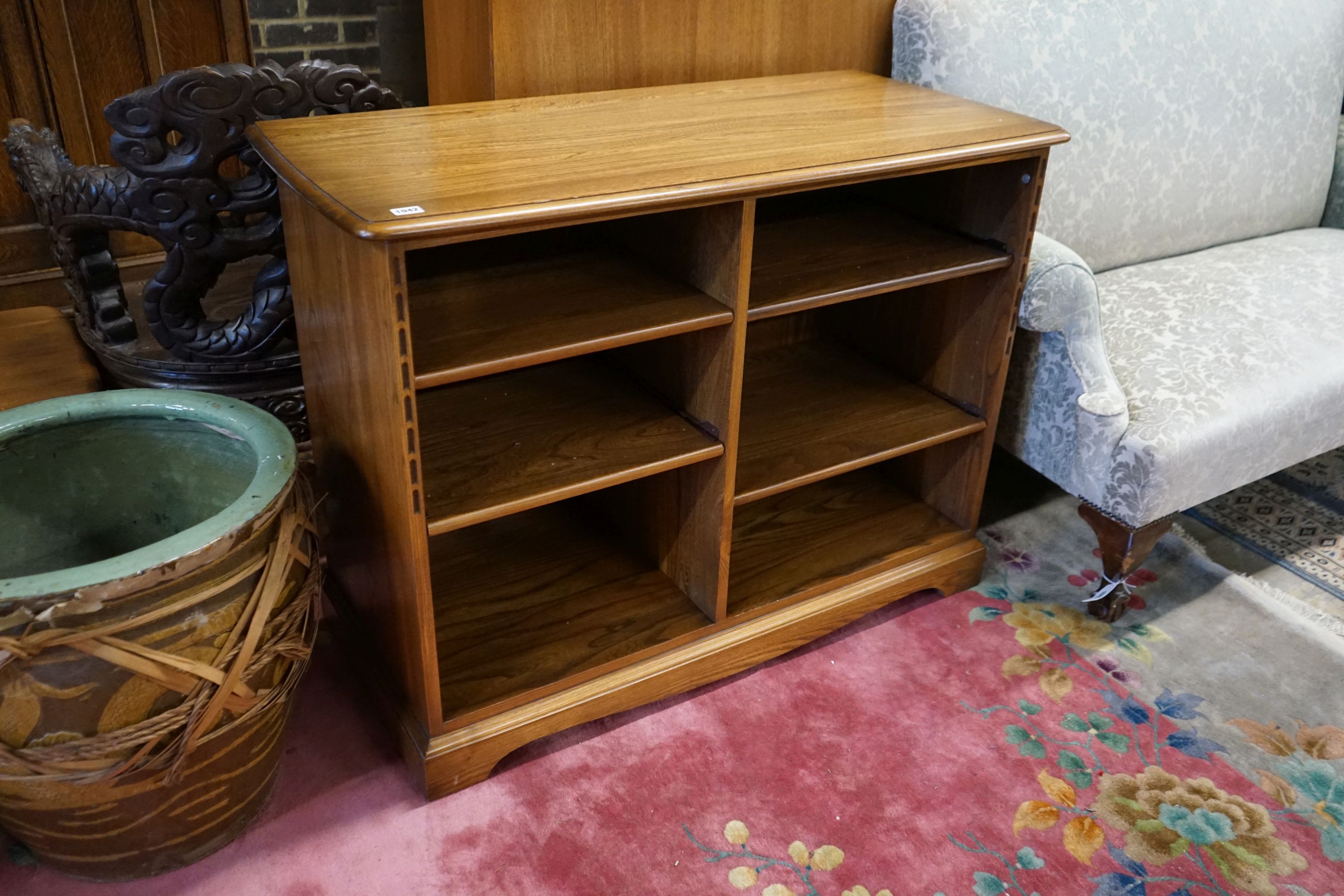 An Ercol elm open media unit, width 110cm, depth 52cm, height 82cm